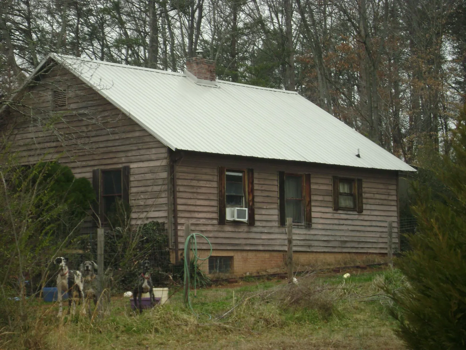 White metal roof on an old wood sided farmhouse, from a Metal Roof Installation job in Cottonport